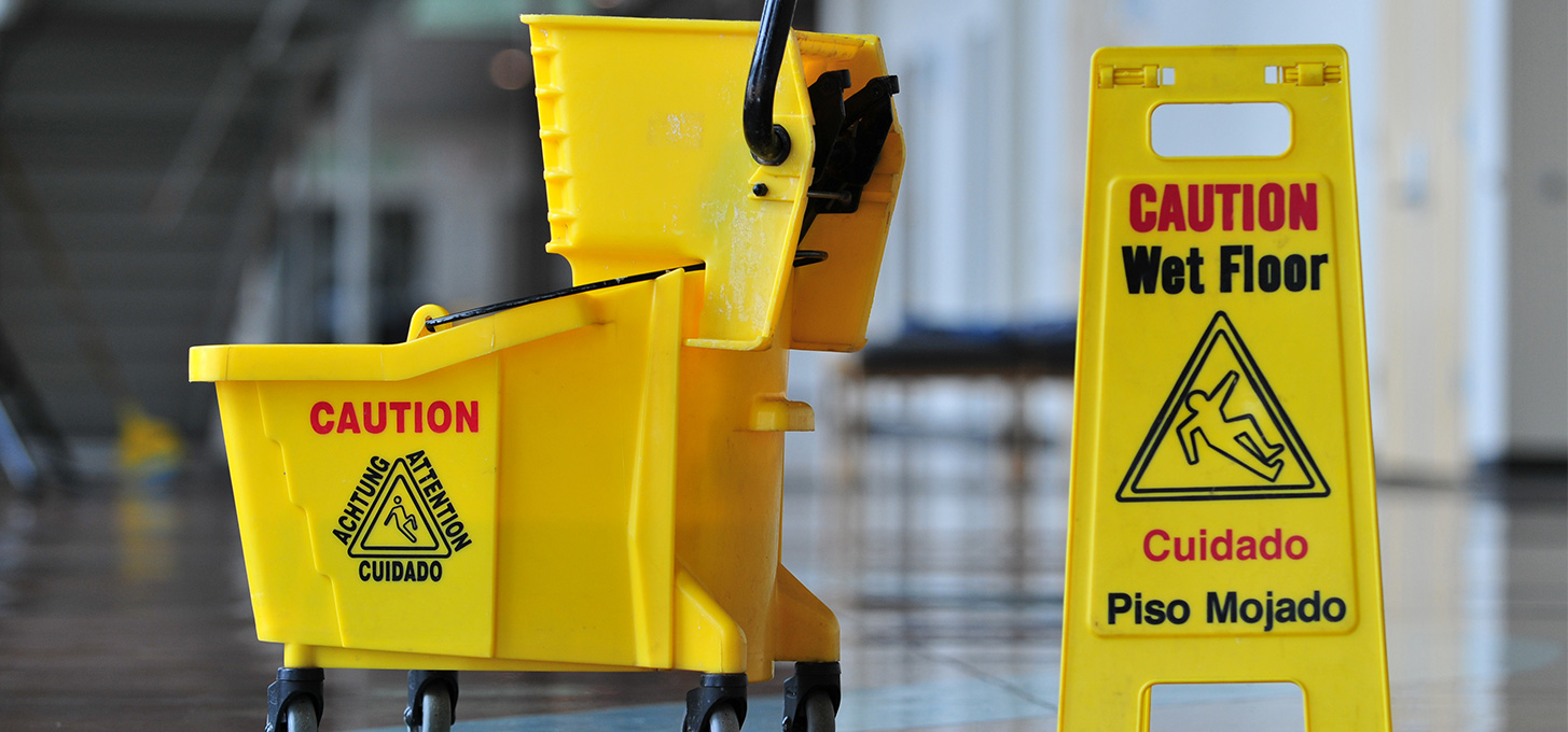 Yellow wet floor sign with a yellow mop and bucket
